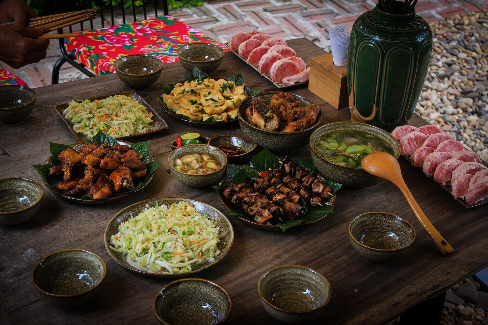 A long table of Vietnamese dishes shared family style